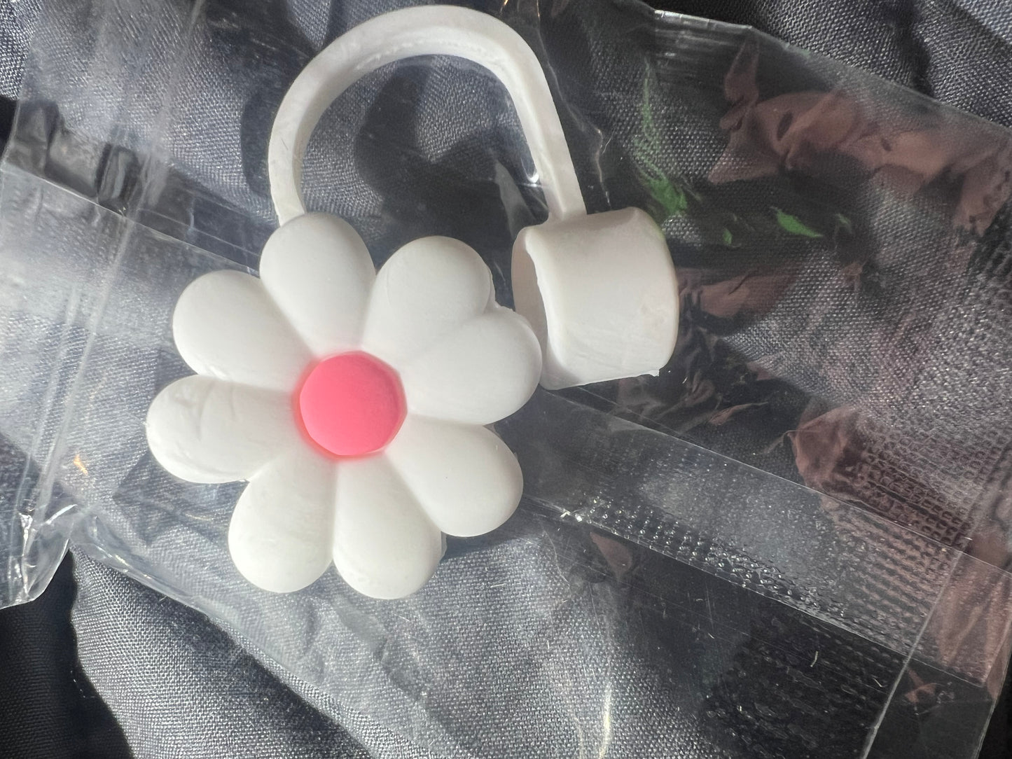 White flower with pink straw topper